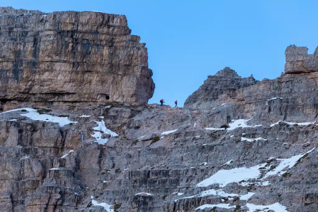 people hiking rocks italian alps